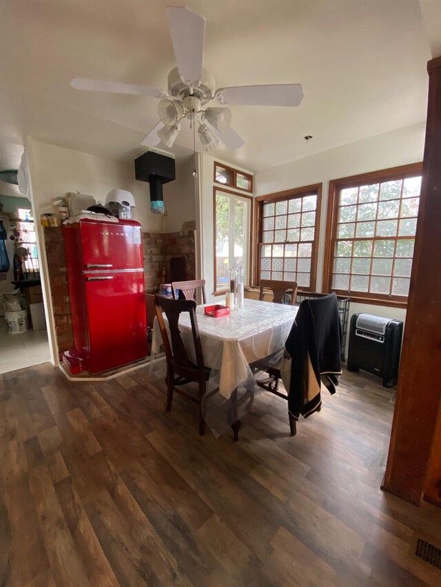 dining area with wood finished floors, visible vents, and a ceiling fan