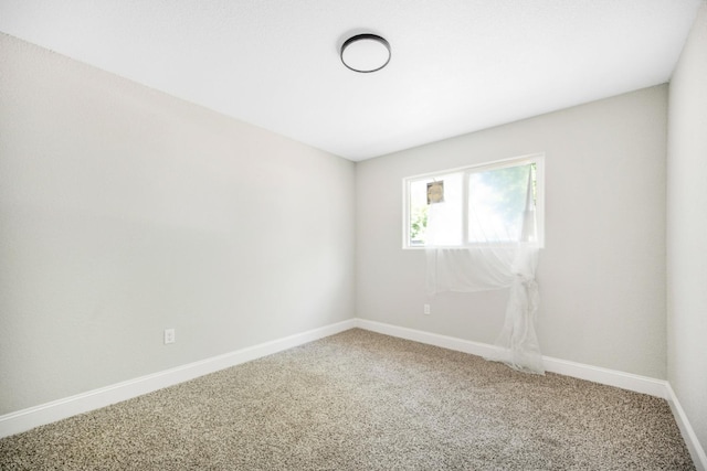 empty room with carpet floors and baseboards