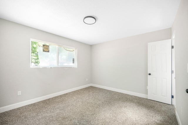 carpeted spare room with baseboards