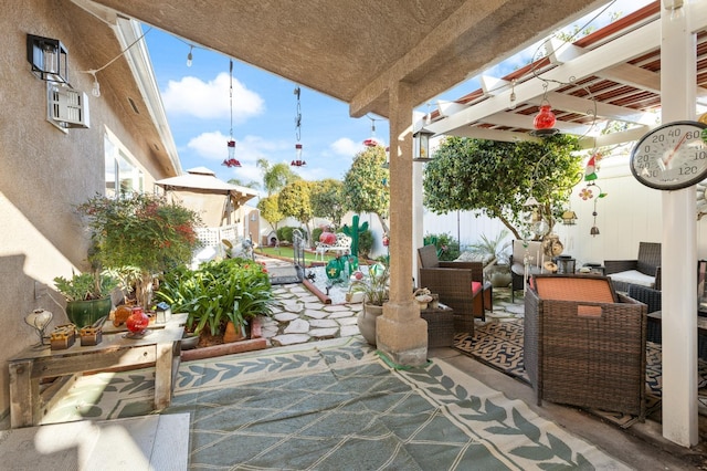 view of patio featuring fence and an outdoor hangout area