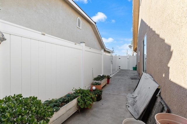 view of property exterior featuring a patio area, fence, and stucco siding