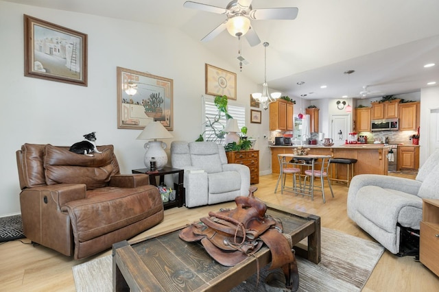 living area featuring lofted ceiling, light wood-style floors, recessed lighting, and ceiling fan with notable chandelier