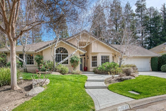 ranch-style home featuring an attached garage, driveway, a front lawn, and stucco siding