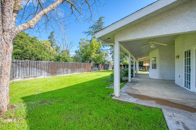 view of yard with a fenced backyard, a patio, and ceiling fan