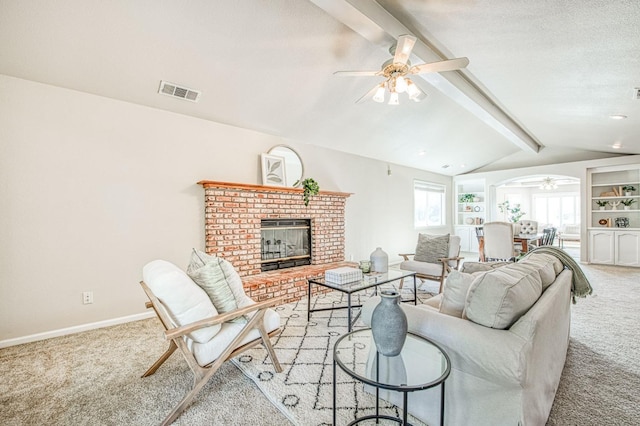 living room featuring light colored carpet, visible vents, vaulted ceiling with beams, and a fireplace