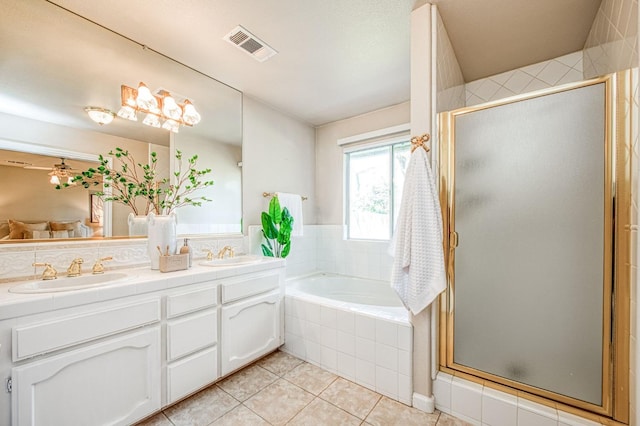 full bath with double vanity, a garden tub, visible vents, and a sink