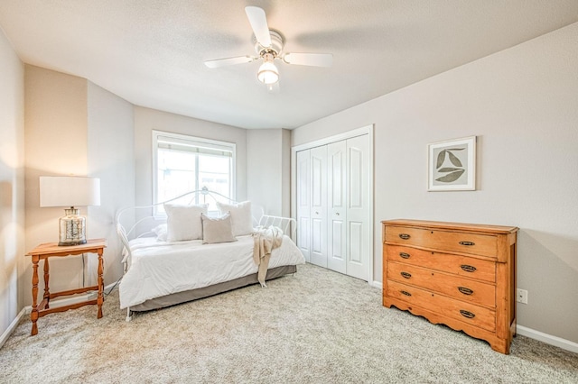 bedroom featuring a closet, carpet flooring, a ceiling fan, and baseboards