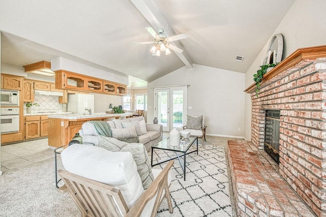 living area with vaulted ceiling with beams, a fireplace, visible vents, baseboards, and french doors