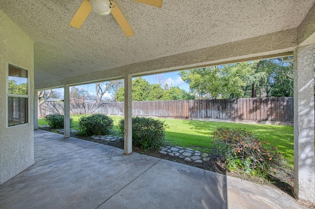 view of patio with a fenced backyard and ceiling fan