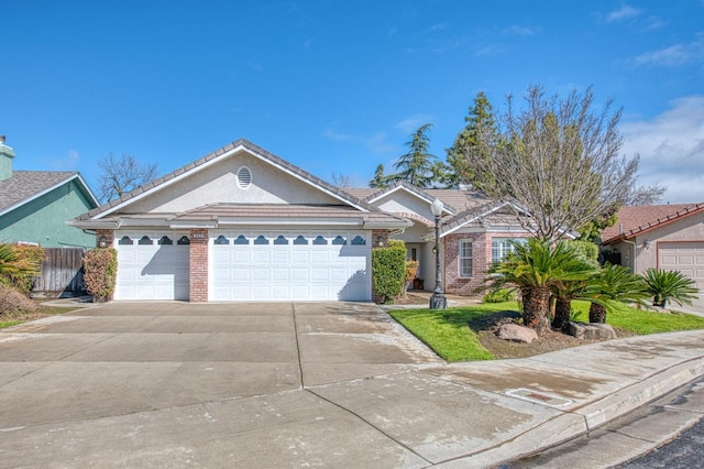 ranch-style house featuring a garage, driveway, brick siding, and stucco siding