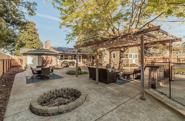 view of patio / terrace featuring an outdoor living space with a fire pit, a fenced backyard, an outdoor structure, a pergola, and outdoor dining space