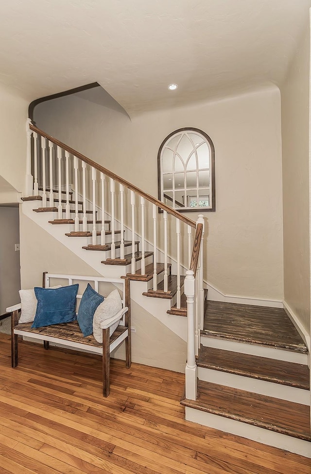 stairway with recessed lighting and hardwood / wood-style floors