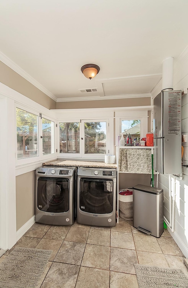 laundry area featuring crown molding, laundry area, plenty of natural light, and washing machine and clothes dryer