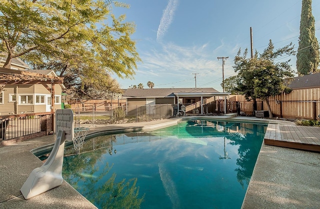 view of swimming pool featuring a diving board, a patio area, a fenced backyard, and a fenced in pool