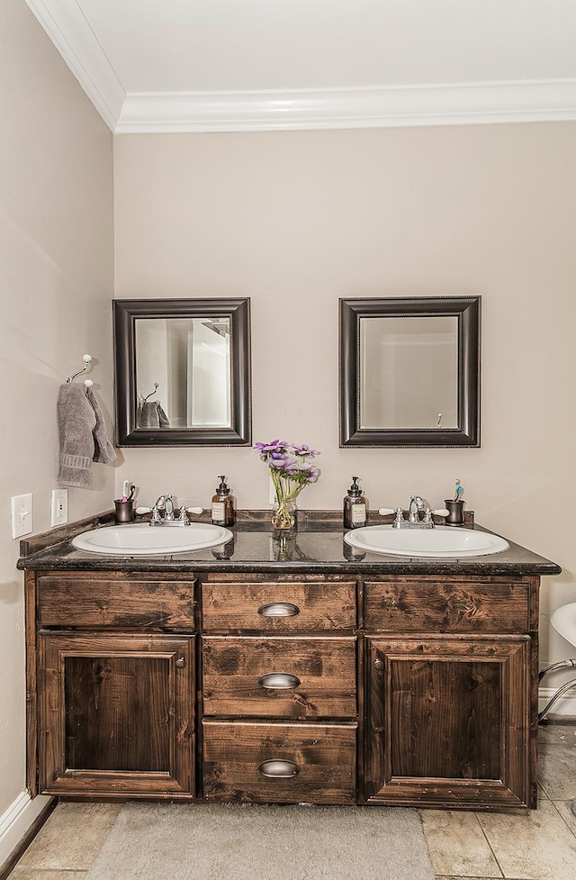 bathroom featuring ornamental molding, a sink, and double vanity