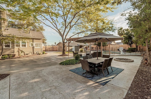 view of patio with entry steps, an outdoor fire pit, outdoor dining space, and fence