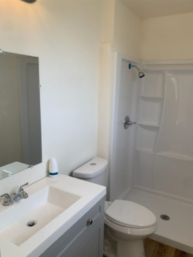 full bath with toilet, a shower stall, and vanity