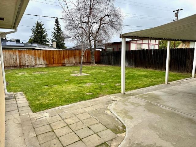 view of yard with a fenced backyard and a patio