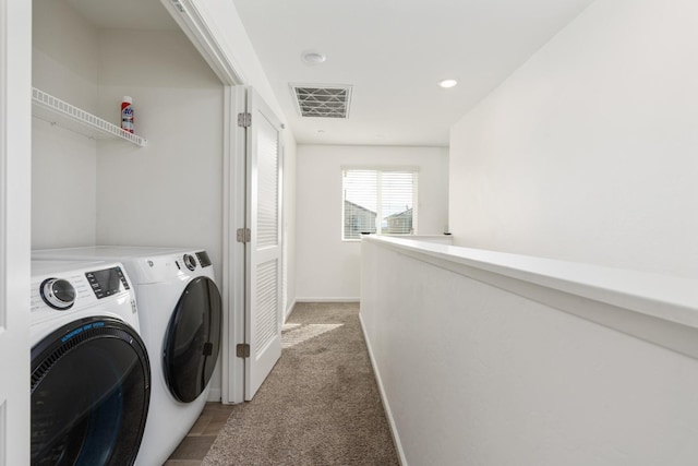 laundry area featuring light carpet, laundry area, visible vents, baseboards, and washer and clothes dryer