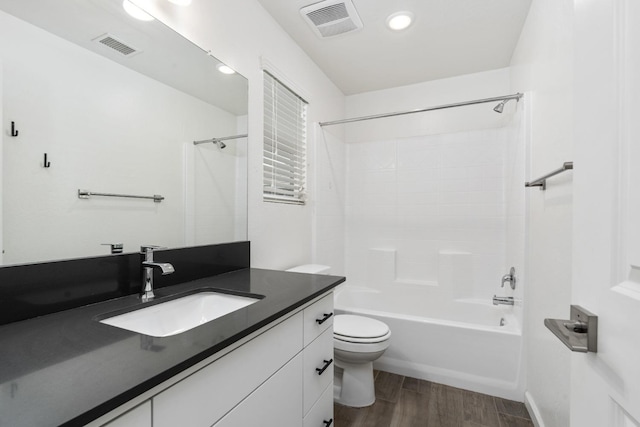 full bathroom with toilet, wood finished floors, vanity, visible vents, and shower / bathing tub combination