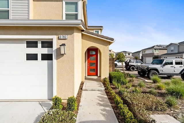 doorway to property with a residential view and stucco siding