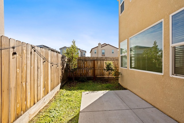 view of yard featuring a patio area and a fenced backyard