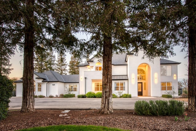 view of front of property featuring a standing seam roof and stucco siding