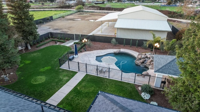 view of pool with a fenced in pool, a fenced backyard, and a yard