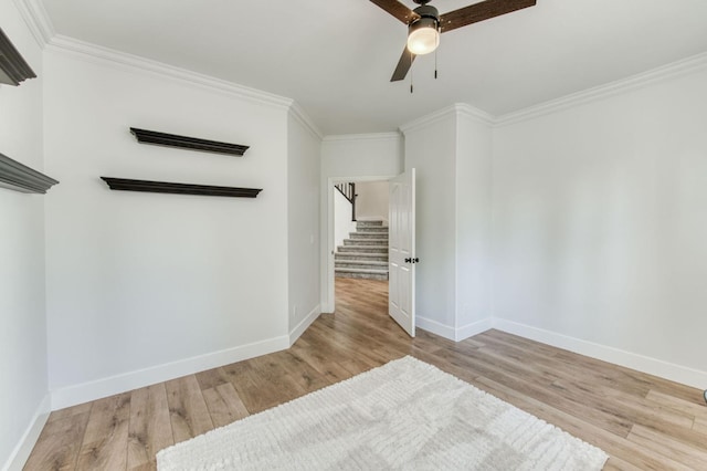 spare room featuring ornamental molding, wood finished floors, and baseboards