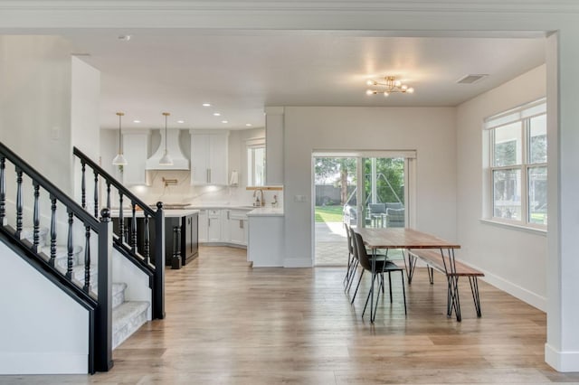 dining area with stairs, recessed lighting, light wood-style flooring, and baseboards