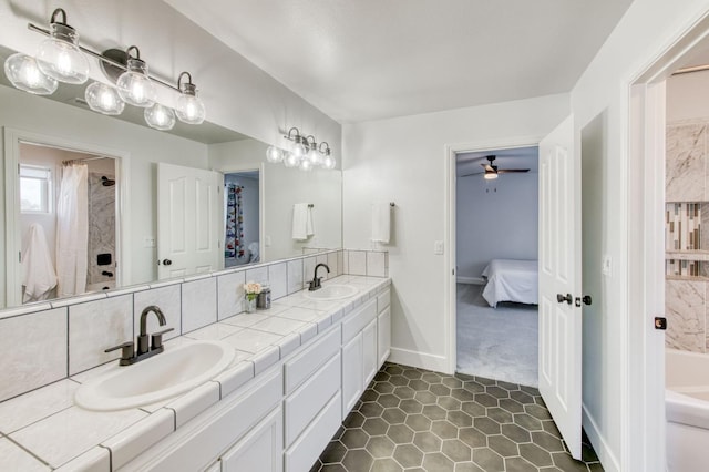 bathroom with ensuite bathroom, double vanity, a sink, and a bathing tub