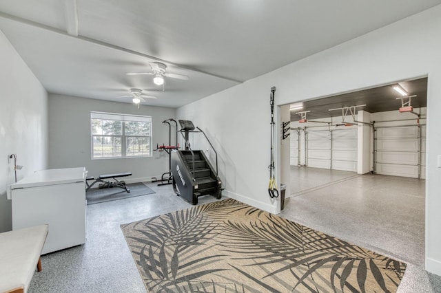 workout room with a garage, ceiling fan, and baseboards