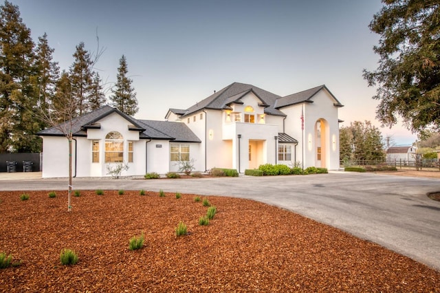 view of front of home with driveway and fence