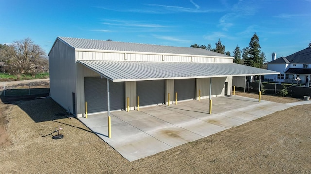 view of front facade featuring an attached carport and metal roof