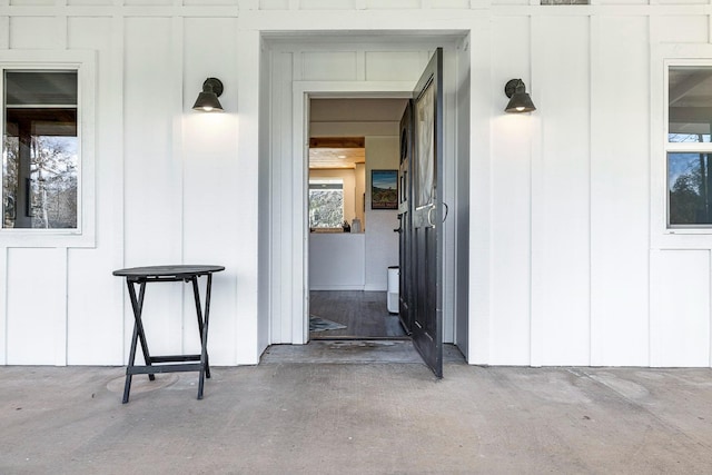 view of exterior entry with board and batten siding