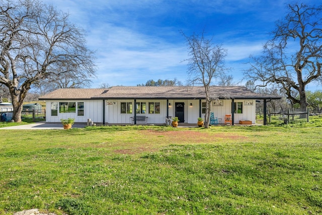 ranch-style house featuring board and batten siding, a front yard, fence, and a porch