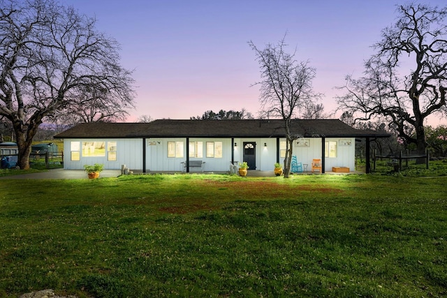 single story home with fence and a lawn