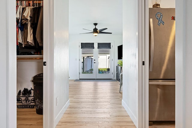 hall with french doors, wood finished floors, and baseboards