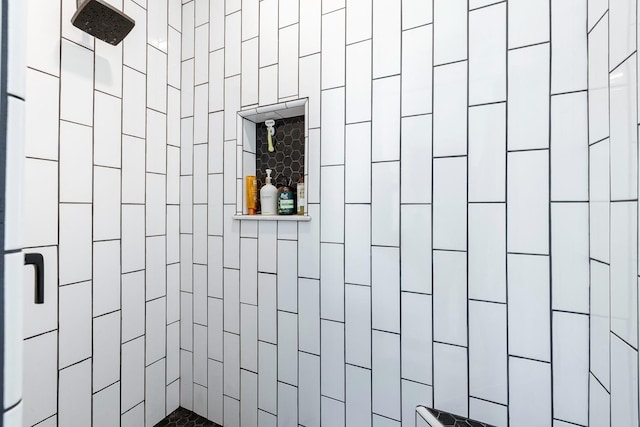 bathroom with a tile shower