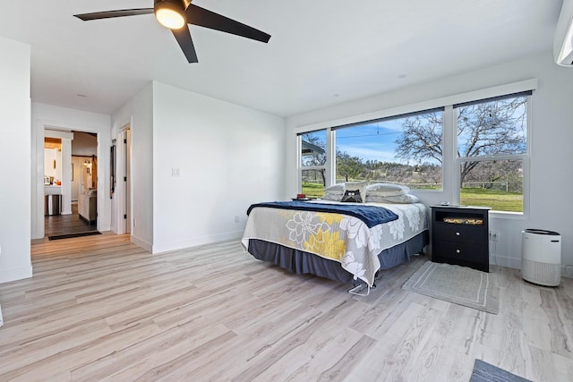 bedroom featuring light wood finished floors, ceiling fan, and baseboards