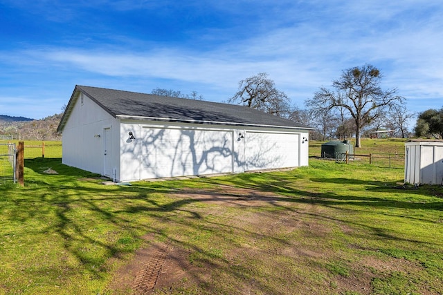 exterior space featuring fence and an outbuilding