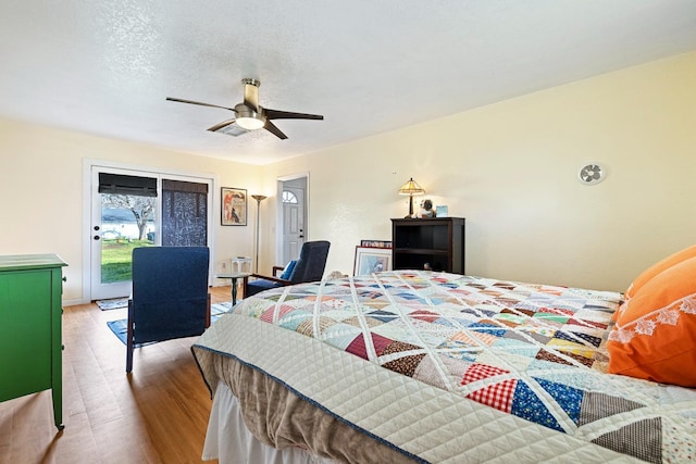 bedroom featuring visible vents, a ceiling fan, access to outside, a textured ceiling, and light wood-type flooring