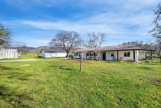 view of yard with an outbuilding and fence