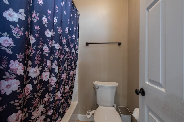 bathroom with shower / bath combination with curtain and toilet