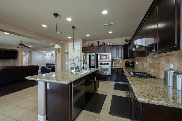 kitchen with stainless steel appliances, open floor plan, visible vents, and a sink