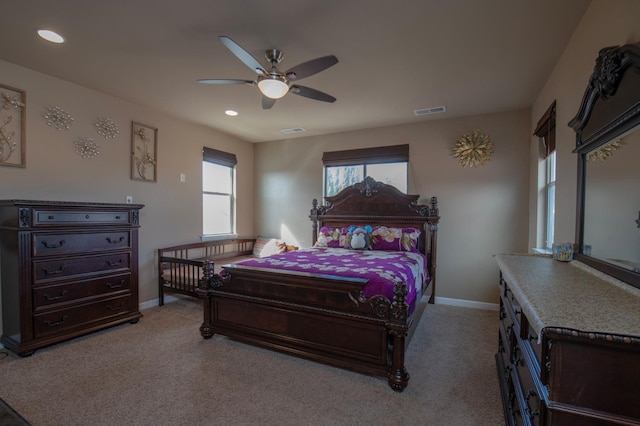 bedroom with light colored carpet, visible vents, and baseboards