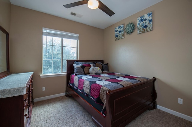 carpeted bedroom with visible vents, ceiling fan, and baseboards