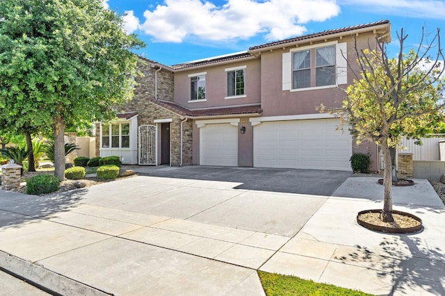 2188 Whiteash Ave, Clovis, CA 93619 - view of front of home featuring an attached garage, concrete driveway, stucco siding, stone siding, and a tile roof