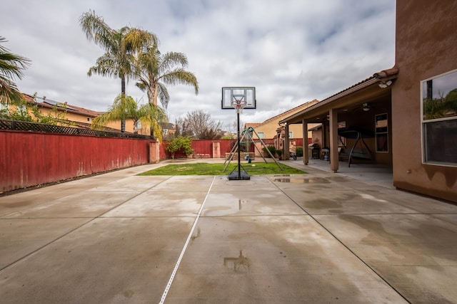 view of patio / terrace featuring a fenced backyard and a playground