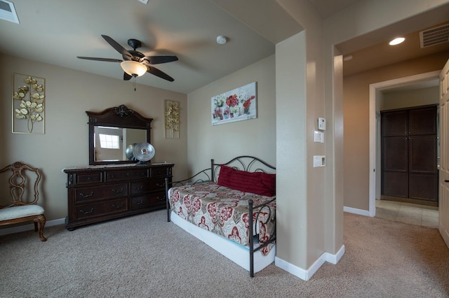 bedroom with light carpet, baseboards, visible vents, and a ceiling fan